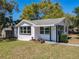 Well-maintained home with white siding, contrasting black window trim, complemented by manicured landscaping and green lawn at 218 W Magnolia St, Clermont, FL 34711