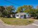 Inviting home with manicured lawn, side street access, with a well-maintained white exterior and black window frames at 218 W Magnolia St, Clermont, FL 34711