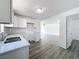 Well-lit kitchen featuring white cabinets, granite counters, and an open view to the main living area at 218 W Magnolia St, Clermont, FL 34711