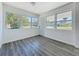 Sun-filled living room featuring updated laminate floors and freshly painted walls and trim at 218 W Magnolia St, Clermont, FL 34711