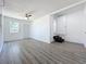 Spacious living room offering gray wood-look floors, a ceiling fan, and lots of natural light at 218 W Magnolia St, Clermont, FL 34711