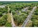 An aerial view showcases the home and surrounding property, bordered by mature trees at 31632 Spruce Dr, Eustis, FL 32736