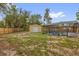 The backyard features a screened-in pool, storage shed and wooden privacy fence at 31632 Spruce Dr, Eustis, FL 32736