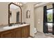 Bathroom with double sink vanity, ornate mirror, tile flooring, toilet, and window at 31632 Spruce Dr, Eustis, FL 32736