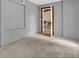 Bedroom with gray walls, beige carpet, and a doorway to a dining area at 31632 Spruce Dr, Eustis, FL 32736