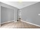 Bedroom featuring tile floors, gray walls, open closet, and white trim at 31632 Spruce Dr, Eustis, FL 32736