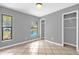 Bedroom with tiled floors, gray walls, and view of the pool at 31632 Spruce Dr, Eustis, FL 32736
