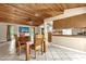 Open-concept dining room with wood-paneled ceiling and tile flooring adjacent to the kitchen at 31632 Spruce Dr, Eustis, FL 32736