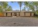 Charming single-story home featuring a central front door, gravel front yard, and mature trees at 31632 Spruce Dr, Eustis, FL 32736