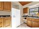 Traditional style kitchen with wooden cabinets, white appliances, and tile flooring at 31632 Spruce Dr, Eustis, FL 32736