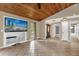 The spacious living room features a wood ceiling, tile flooring, and a built in entertainment center at 31632 Spruce Dr, Eustis, FL 32736