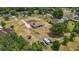 Aerial view of a home site with RV parking surrounded by lush landscaping in a serene neighborhood at 32421 Wolfs Trl, Sorrento, FL 32776