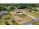 Aerial view of home with long driveway and well-manicured lawn in a peaceful neighborhood setting at 32421 Wolfs Trl, Sorrento, FL 32776