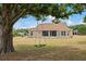Expansive backyard featuring a tree swing, a screened-in porch, and mature trees, perfect for relaxation and outdoor enjoyment at 32421 Wolfs Trl, Sorrento, FL 32776