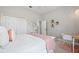 Bright bedroom with a large bed, a closet, a desk, and decor for a comfortable and stylish living space at 32421 Wolfs Trl, Sorrento, FL 32776