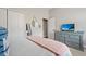 Cozy bedroom with dresser, TV, and neutral decor at 32421 Wolfs Trl, Sorrento, FL 32776