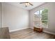 Bedroom features wood-look tile flooring and a large arched window at 32421 Wolfs Trl, Sorrento, FL 32776
