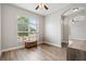 Bedroom features wood-look tile flooring and a large arched window at 32421 Wolfs Trl, Sorrento, FL 32776