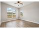 Bright bedroom with laminate floors, a large window, and neutral walls at 32421 Wolfs Trl, Sorrento, FL 32776