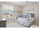 Bright bedroom with large window, comfortable bed, and stylish decor at 32421 Wolfs Trl, Sorrento, FL 32776