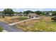 Inviting home with a spacious front lawn and a long driveway leading to the garage at 32421 Wolfs Trl, Sorrento, FL 32776