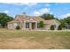 Sprawling single-story home showcasing neutral stucco, manicured landscaping, and an expansive front lawn at 32421 Wolfs Trl, Sorrento, FL 32776
