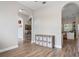 Hallway with wood-look tile flooring, arched doorways, and storage at 32421 Wolfs Trl, Sorrento, FL 32776
