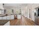 Spacious kitchen featuring granite counters, stainless appliances, wood floors, and natural light at 32421 Wolfs Trl, Sorrento, FL 32776