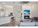 Open-concept living room with fireplace, kitchen bar, and wood-look tile floors at 32421 Wolfs Trl, Sorrento, FL 32776