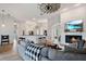 Open concept living room with fireplace, bar seating and wood-look tile floors at 32421 Wolfs Trl, Sorrento, FL 32776
