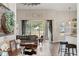 Bright living room with backyard views, wood-look tile, and farmhouse decor at 32421 Wolfs Trl, Sorrento, FL 32776