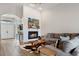 Cozy living room with fireplace, wood-look tile, and comfortable seating at 32421 Wolfs Trl, Sorrento, FL 32776