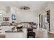 Open concept kitchen and living room featuring granite countertops and stylish décor at 32421 Wolfs Trl, Sorrento, FL 32776