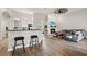 Open concept living space with fireplace and kitchen, perfect for entertaining at 32421 Wolfs Trl, Sorrento, FL 32776