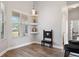 Bright nook with built-in shelves and a decorative wooden chair in an open floor plan at 32421 Wolfs Trl, Sorrento, FL 32776