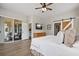 Well-lit bedroom featuring an exit to the porch and sliding barn doors, creating an inviting and comfortable space at 32421 Wolfs Trl, Sorrento, FL 32776
