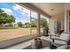 Enjoyable screened patio with comfortable seating, a grill, and views of the surrounding landscape at 32421 Wolfs Trl, Sorrento, FL 32776