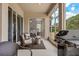 Relaxing screened patio with comfortable seating, grill, and a view into the adjacent bedroom at 32421 Wolfs Trl, Sorrento, FL 32776