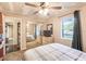 Bedroom featuring a ceiling fan, a mirror closet, and a window view at 3247 S Polk Ave, Lakeland, FL 33803