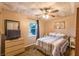 Comfortable bedroom featuring a ceiling fan, a window, and a queen-size bed at 3247 S Polk Ave, Lakeland, FL 33803