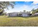 Well-maintained home featuring a spacious yard with a neatly manicured lawn and mature trees at 3247 S Polk Ave, Lakeland, FL 33803