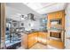 Open-concept kitchen featuring stainless steel appliances and granite countertops adjacent to living area at 3247 S Polk Ave, Lakeland, FL 33803