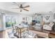 Bright and airy living room with hardwood floors, ceiling fans, and sliding doors to the outside at 3247 S Polk Ave, Lakeland, FL 33803