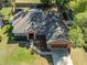 Aerial view of a well-maintained single-story home with lush landscaping and an attached two-car garage at 5416 Oxford Manor Cir, Lakeland, FL 33810