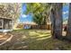 Large backyard with mature trees and a playhouse at 5416 Oxford Manor Cir, Lakeland, FL 33810