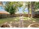 Well-maintained backyard with mature trees and a wooden fence at 5416 Oxford Manor Cir, Lakeland, FL 33810