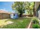 Fenced backyard with mature trees, playhouse, and well-maintained lawn provides a private outdoor space at 5416 Oxford Manor Cir, Lakeland, FL 33810