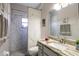 Bright bathroom featuring marble tile, walk-in shower, and granite countertop sink at 5416 Oxford Manor Cir, Lakeland, FL 33810
