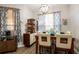 Stylish dining room boasting a contemporary table set, charming window treatments, and functional storage at 5416 Oxford Manor Cir, Lakeland, FL 33810