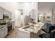 Well-lit kitchen showcases stainless steel appliances, granite countertops, and a view of the dining area at 5416 Oxford Manor Cir, Lakeland, FL 33810